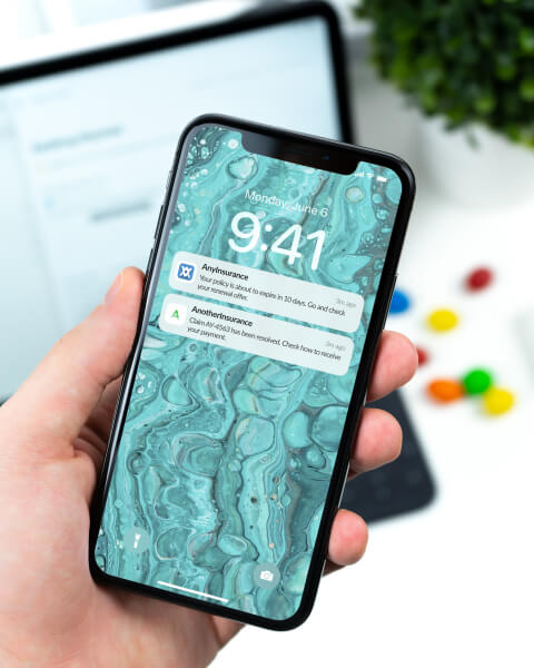 A hand holding iPhone with InsurancePass open